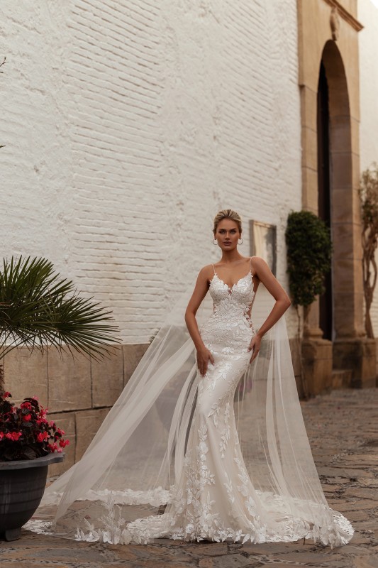 Découvrez l’incroyable robe de mariée sirène en dentelle modèle Darma, avec décolleté en V, fines bretelles, dos transparent brodé et traîne longue à Marseille près d’Aix-en-Provence :